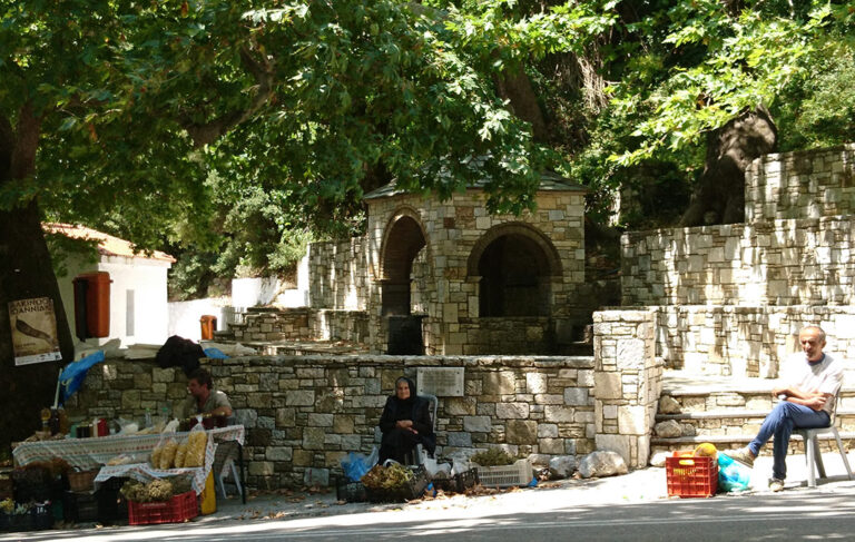 Road at Steni village in Euboea Greece with people selling goods by the road